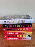 Stacked side view showing all six book titles and formats