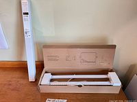 Sealed retail box and opened inner tray showing LED bar and components