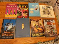 Front covers of all eight books arranged on table