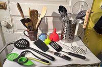 Overview of utensils on counter including holders, funnels, various tools