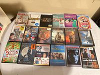 Tabletop shot showing approximately eighteen DVD cases and one large TV series box set arranged in three rows