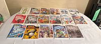 All 17 Wii game cases laid out on table, full lot overview