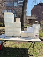 All plastic drawer units displayed on table outdoors