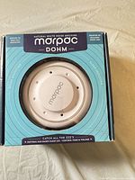 Front of box showing Marpac Dohm natural white noise machine