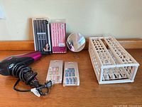 Full lot showing hair dryer, roller packs, nail packs, mirror, organizer