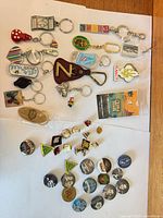 Group shot of entire lot showing keychains, pins and buttons