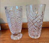 Both cut crystal vases side by side
