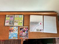 Binder, two jumbo cards, sealed refill pages displayed on table