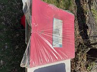 Table in plastic wrap on its side outdoors