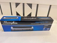 Front of retail box showing Swingline Precision Pro branding and product image