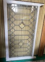 Full view of leaded glass panel within white frame