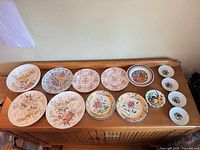 Full layout of all 14 dinnerware pieces on cabinet top