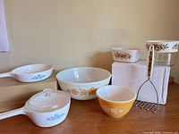 Group shot of all seven pieces showing patterns, sizes and lid