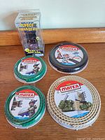 Group shot showing four Mayka tape rolls and Tiny Arcade package