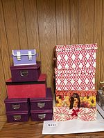 Front view showing stacks of faux-suede, patterned, and leaf-print boxes