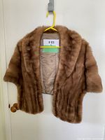 Full front view of mink stole on hanger