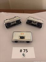 Three Tasco Birell opera glasses open showing lenses