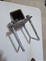 Overall view of bracket showing 2" square receiver tube, plate, and U-bolts