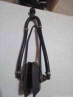 Full view of manual bilge pump with attached hoses