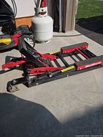 Full view of MotoMaster hydraulic lift in folded position