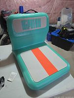 Front view of teal Niphean inflatable seat showing backrest logo and seat pad