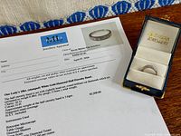 Ring in presentation box beside appraisal sheet