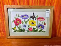 Front view of framed crewel embroidery showing entire design and frame