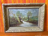 Front view of framed oil painting showing entire artwork and ornate frame