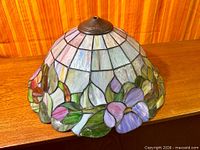 Top view of stained glass dome shade showing leaded glass panels and metal cap