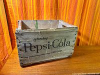 Front view showing Pepsi-Cola lettering and crate construction