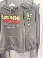 Both hoodies hanging, showing overall color and style