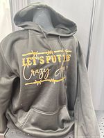 Front view of black hoodie showing full graphic and hood