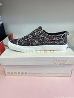 Left side view of entire sneaker on branded box