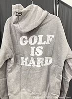 Back view of hoodie showing "GOLF IS HARD" graphic