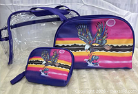 Front view of all three bags standing, showing sizes and artwork
