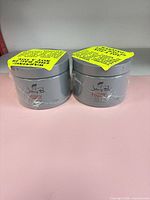 Front view of two sealed Johnny B. Fuddy jars