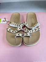 Top view of both sandals showing footbed texture and strap pattern