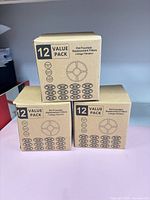 Three unopened boxes labelled '12 Value Pack Pet Fountain Replacement Filters 3-Stage Filtration'