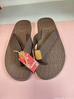 Top view of pair showing footbed texture, size, and tag attached