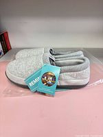 Top view of grey knit cuff Rock Dove slippers with tags