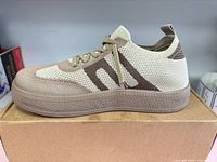 Left side view of beige/brown knit Sunnysweet sneaker on box
