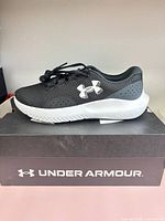 Side view of left sneaker on top of branded box