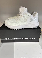 Left side view of both shoes on original Under Armour box