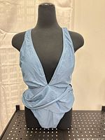 Front view of light blue one-piece swimsuit on mannequin