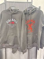 Both Fireball hoodies front view on hangers