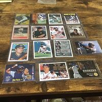All fifteen baseball cards laid out on table in sleeves