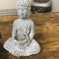 Grey seated Buddha candle holder