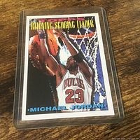 Front of Michael Jordan Topps Reigning Scoring Leader card in holder
