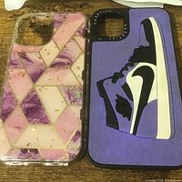 Front view of two smartphone cases showing designs and camera cutouts