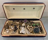 Open blue velvet case showing all jewelry pieces